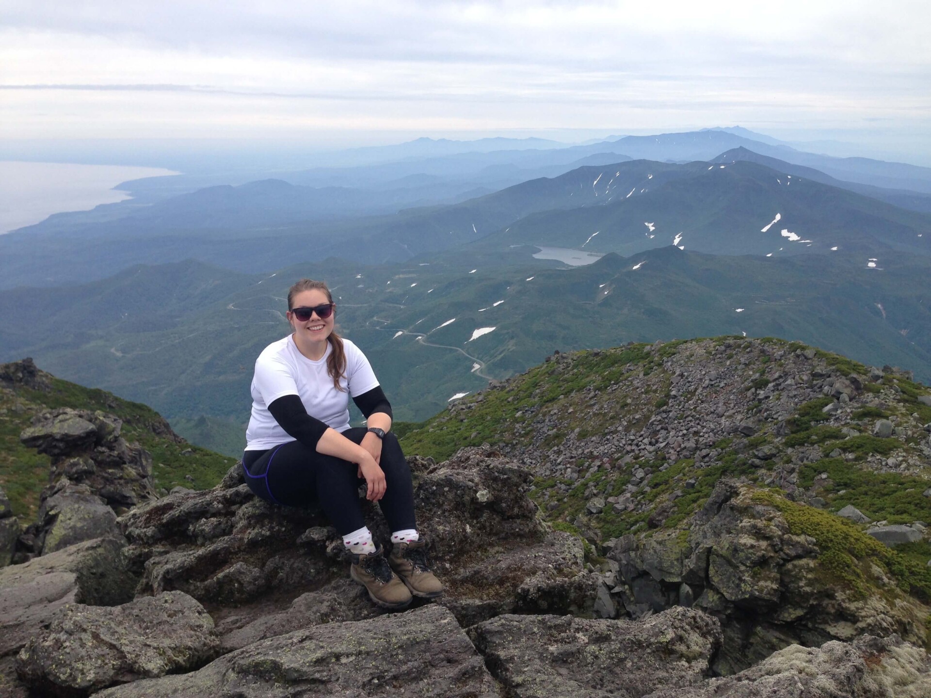 Lauren sitting on top of the summit of Mount Rishiri Hokkaido Japan