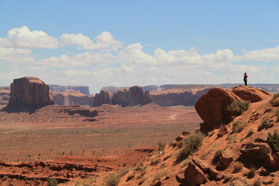 lauren standing on a rock and looking out across monument valley in the united states