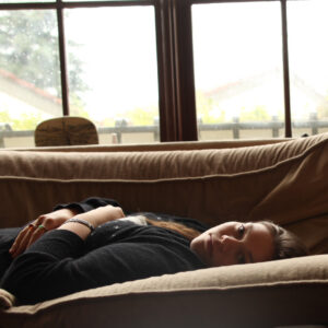 lauren lying on a couch looking into the camera in australia - an english girl in oz