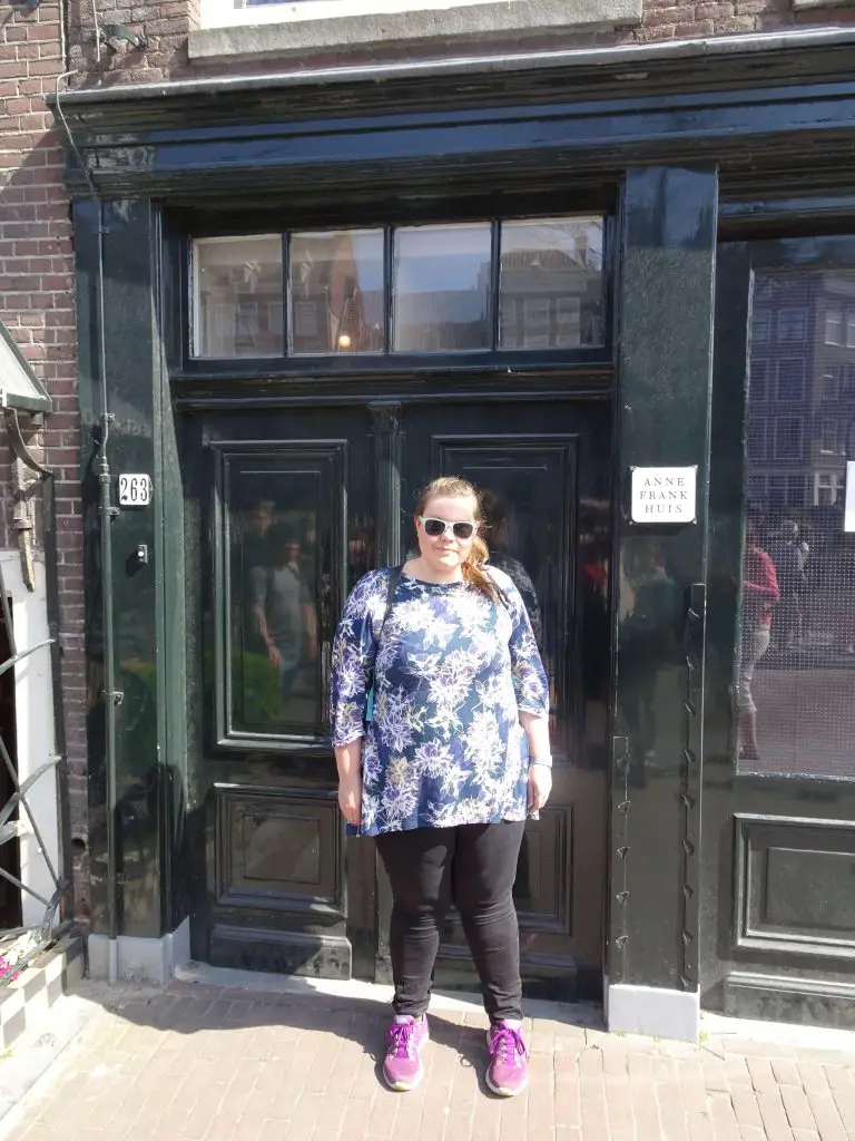 lauren standing outside the entrance to the original anne frank house in amsterdam, netherlands