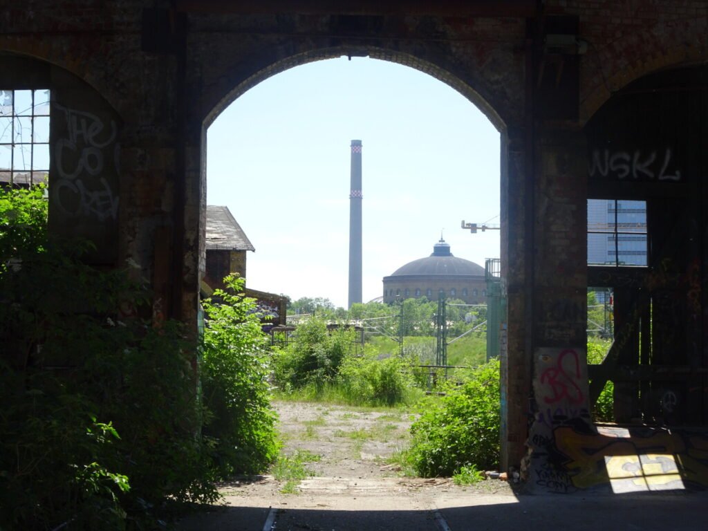 arched doorway with view to a chimney stack, abandoned urbex lost place leipzig germany