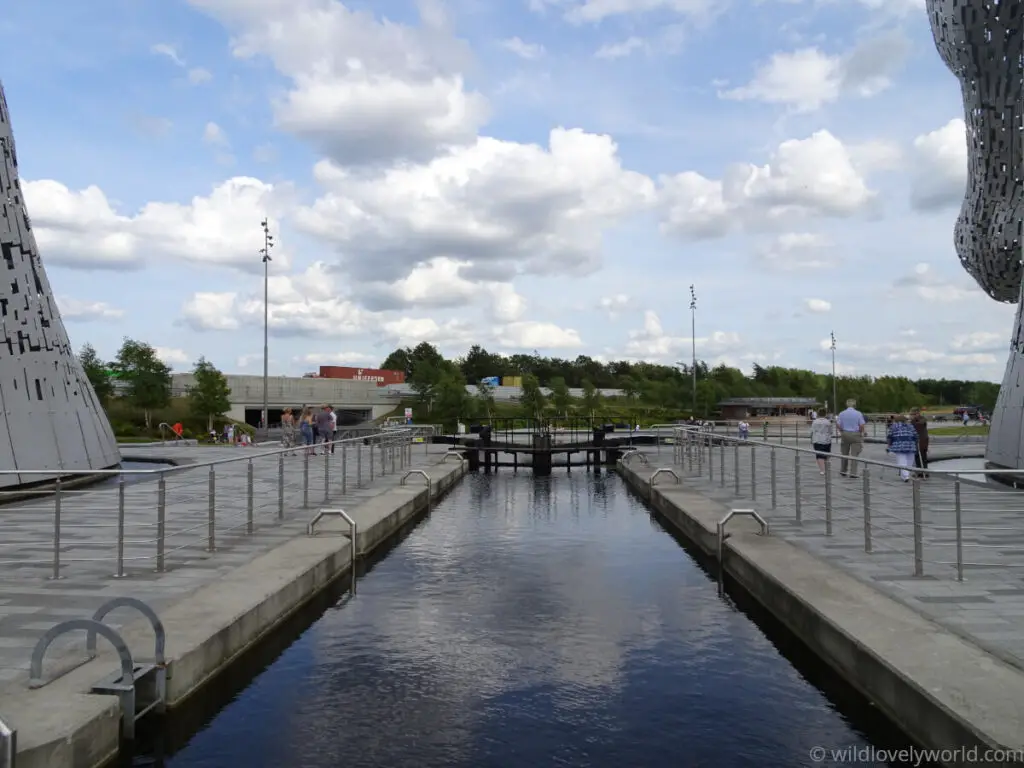 view of the basin of the forth and clyde canal and lock at the base of the kelpies in falkirk