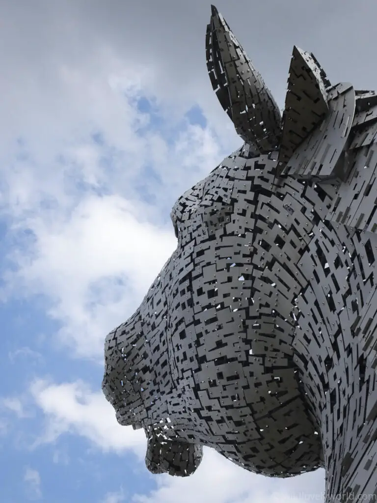 a photograph of the kelpies head up sculpture in falkirk scotland up close showing the stainless steel construction