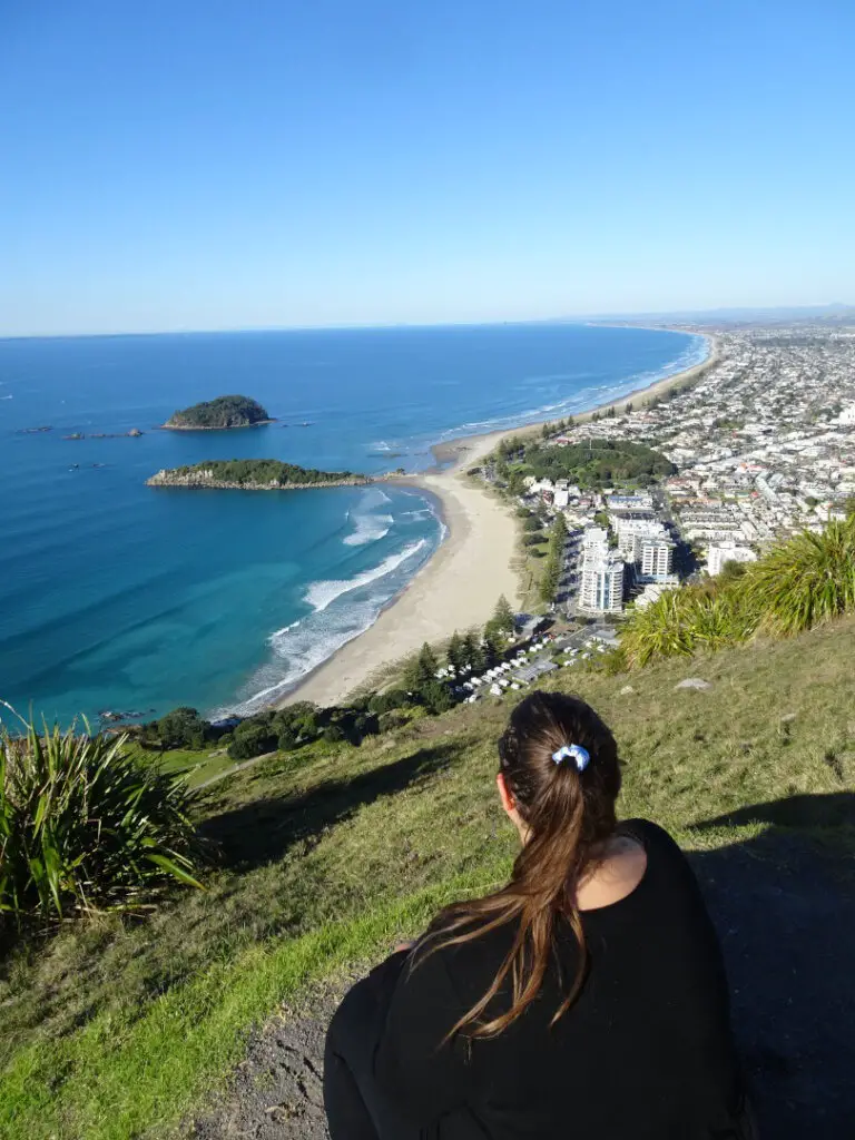 lauren looking over mount maunganui on a sunny day view of ocean and beach new zealand