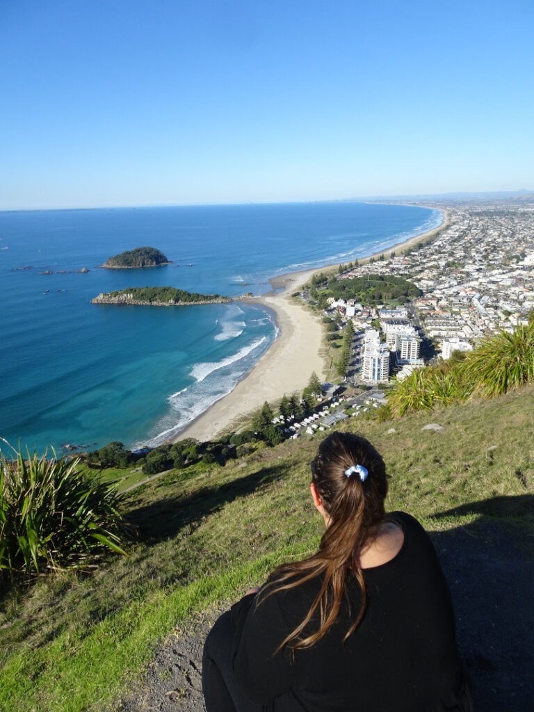 lauren looking over mount maunganui on a sunny day view of ocean and beach new zealand