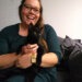 lauren smiling holding black cat sitting become a cat sitter