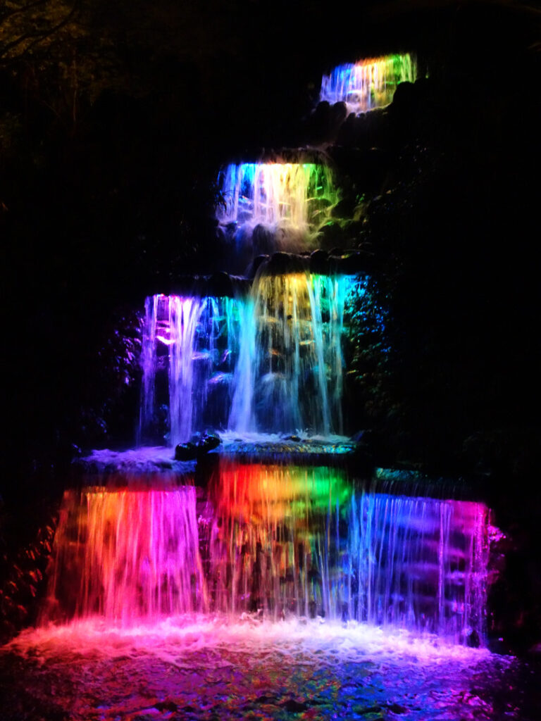 rainbow colours on pukekura waterfall in pukekura park new plymouth festival of lights
