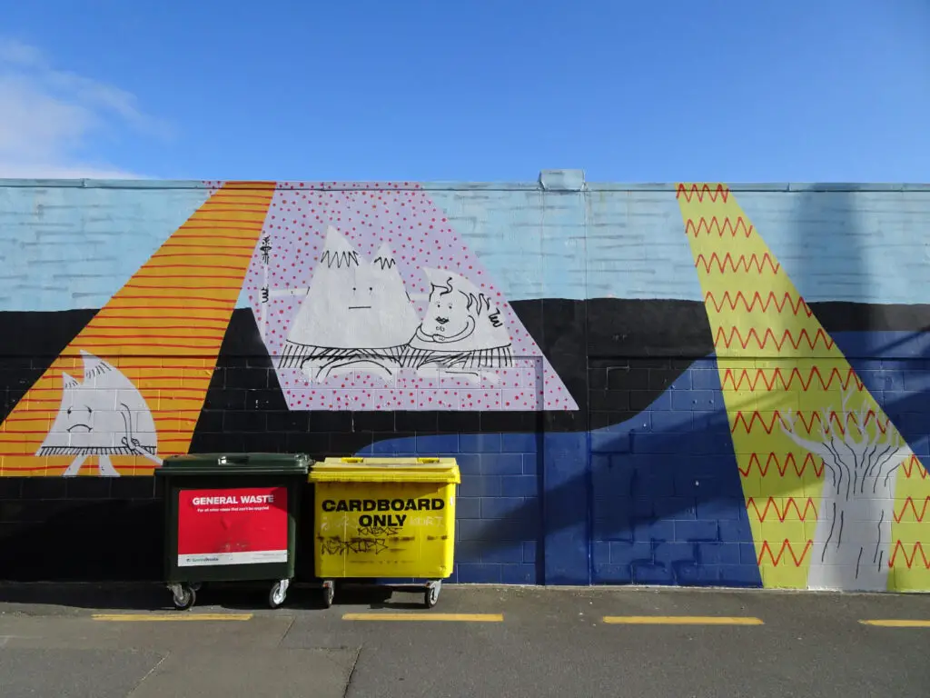 street art mural in taupo of cute triangle characters on a colourful background
