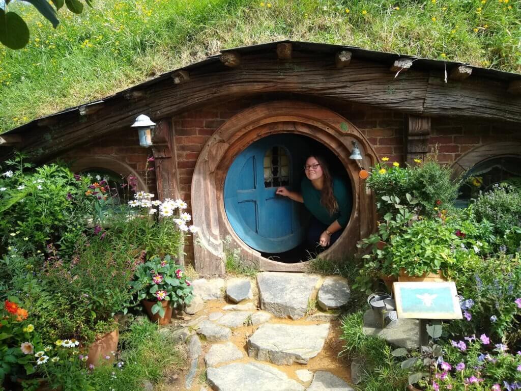 lauren in a hobbiton doorway in new zealand