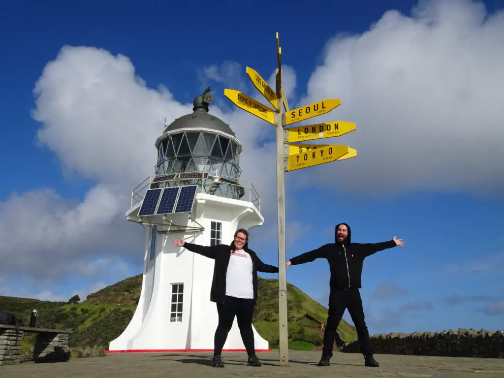 lauren and fiachra at cape reinga in the north island new zealand - a must do experience