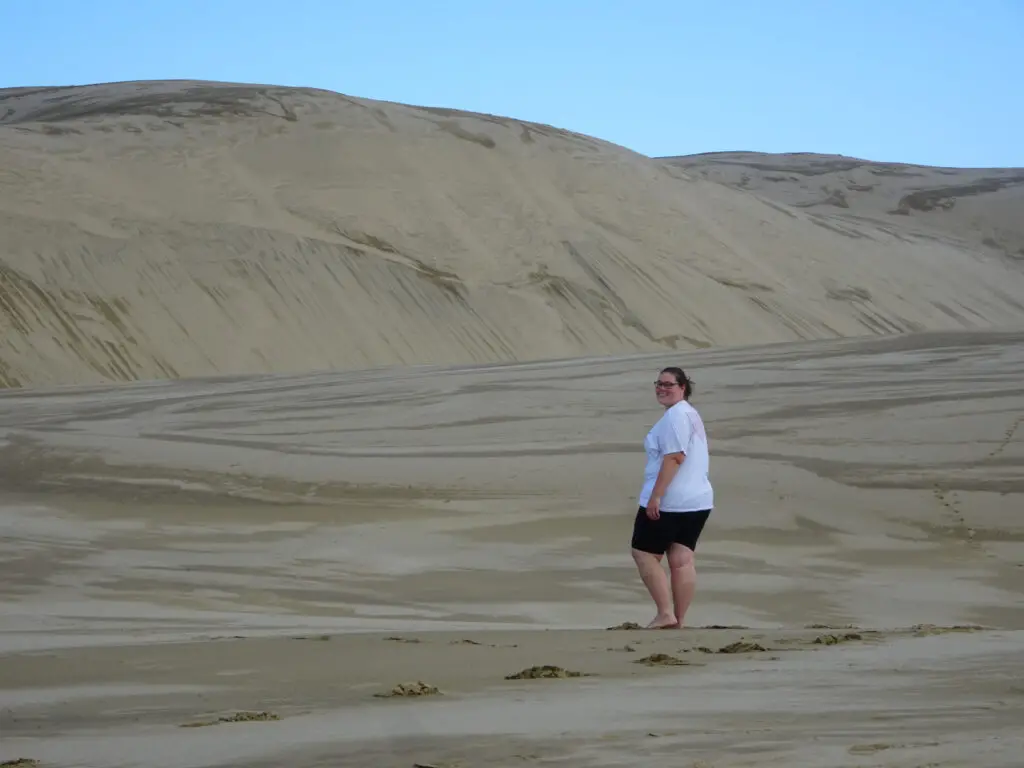 lauren enjoying te paki sand dunes in northland new zealand