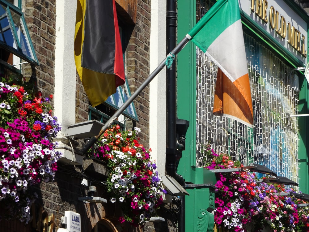 irish flag and flowers on building in temple bar dublin - wildlovelyworld