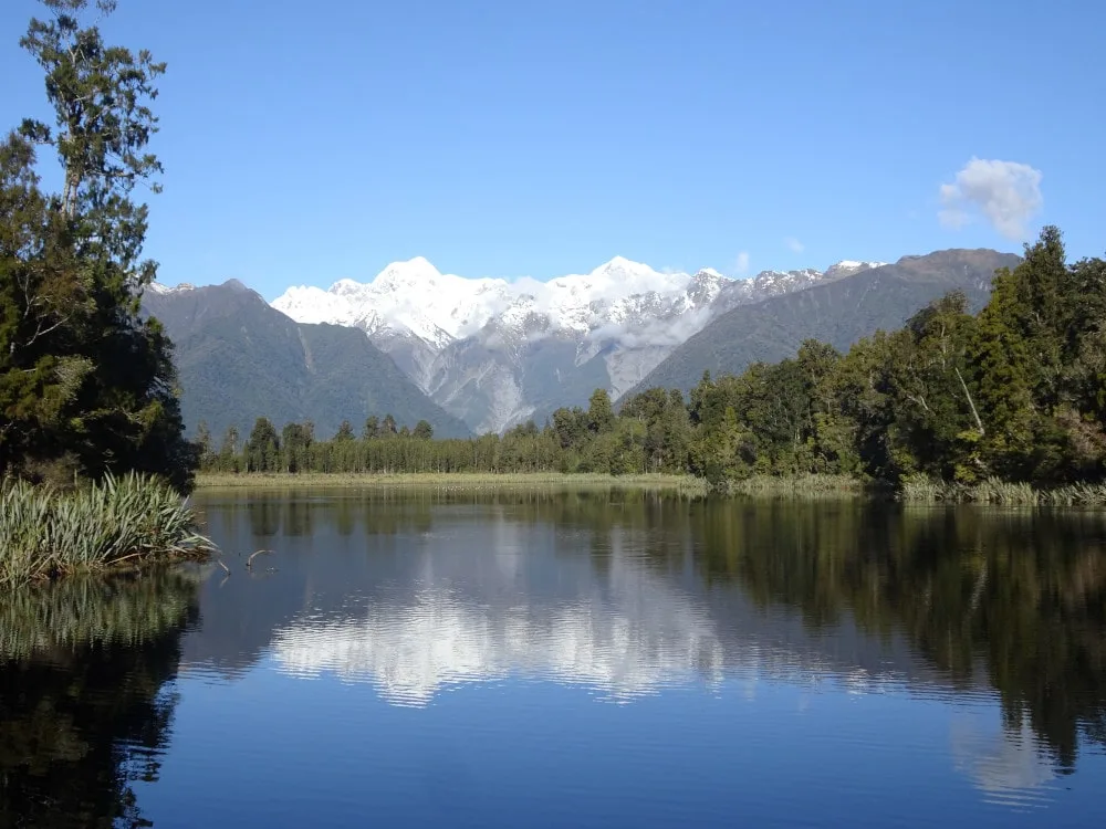 view of lake matheson from the reflection island viewpoint fox glacier