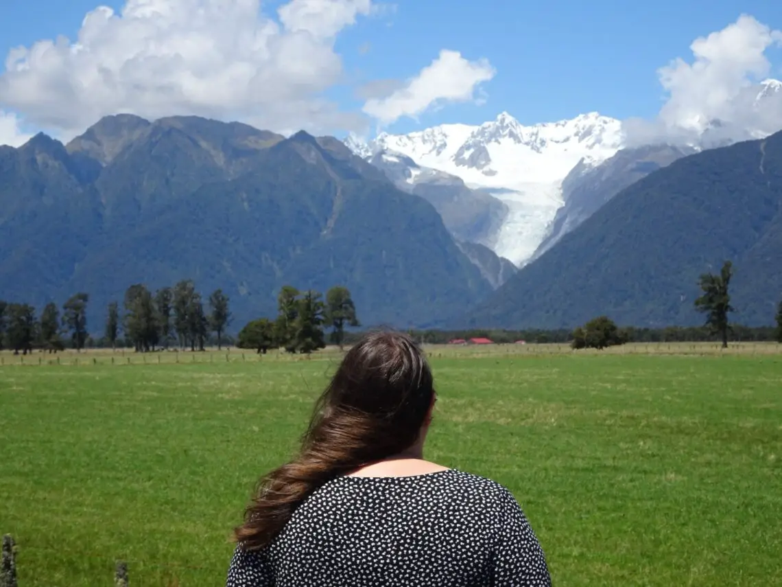 lauren viewing fox glacier on the west coast of the south island new zealand - best glaciers to visit new zealand