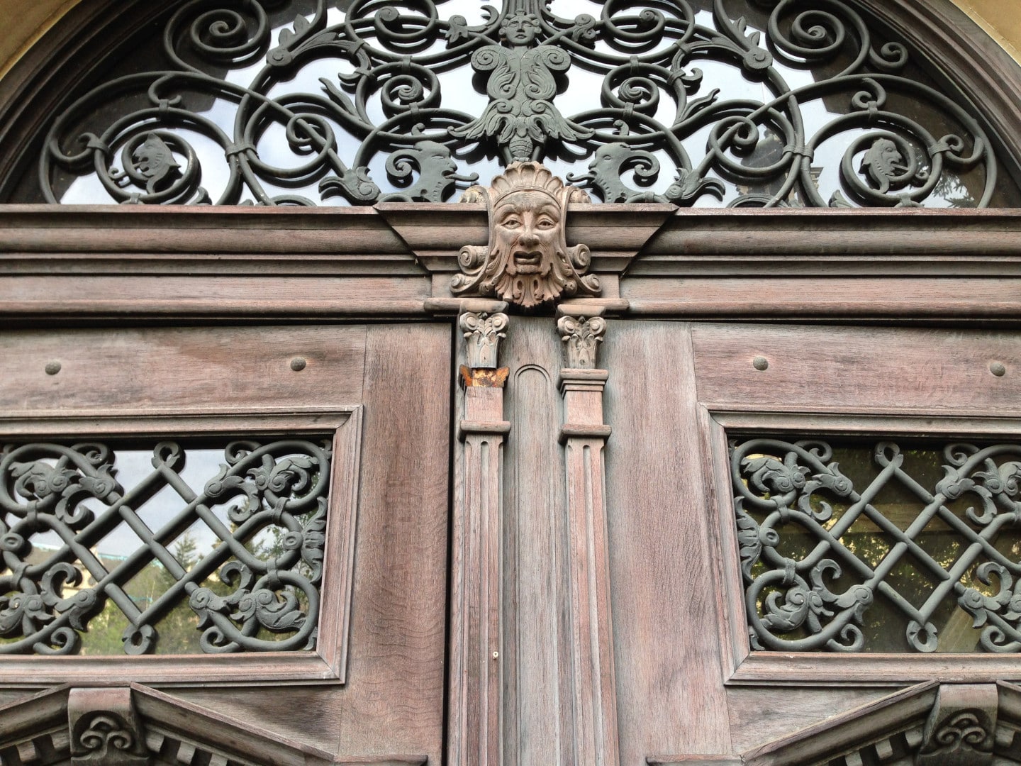 carved wooden doorway with face motif at the gluck kingdom