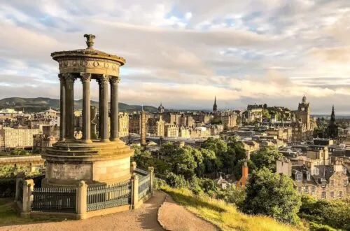 calton hill edinburgh view with dugald stewart monument, balmoral hotel and edinburgh castle - everything you need to know about calton hill in edinburgh - wild lovely world travel blog