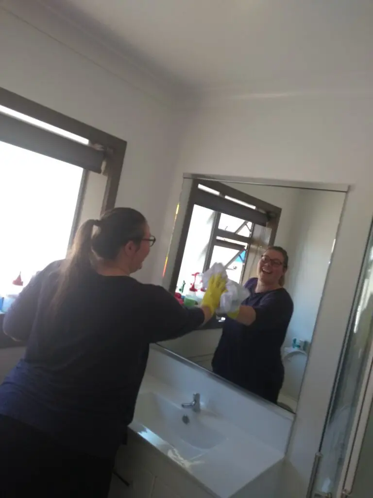 lauren housekeeping cleaning a mirror