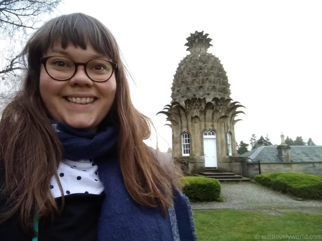 lauren smiling at the camera in a selfie photo with the dunmore pineapple building in the background
