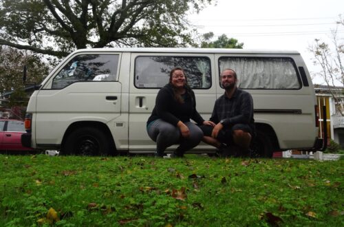 lauren and fiachra with their nissan caravan campervan in auckland new zealand