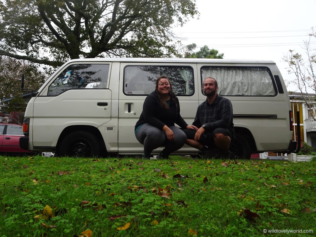 lauren and fiachra with their nissan caravan campervan in auckland new zealand