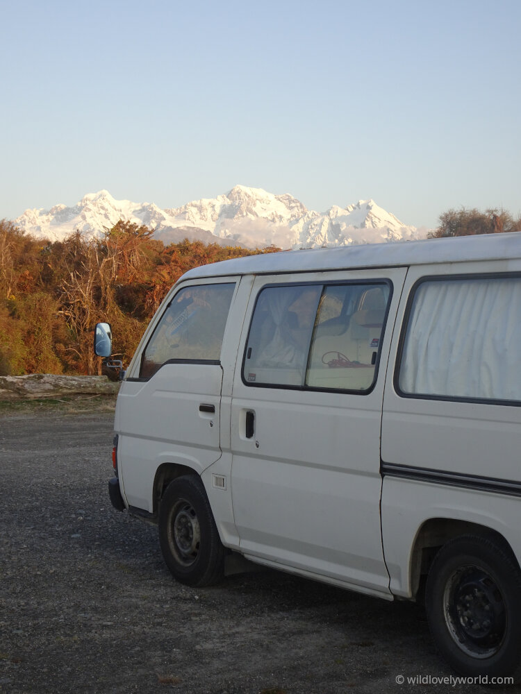 nissan caravan campervan at gillespies beach fox glacier with view of mountains in background