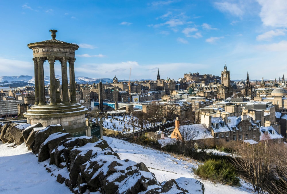 view of edinburgh from calton hill in the snow in winter