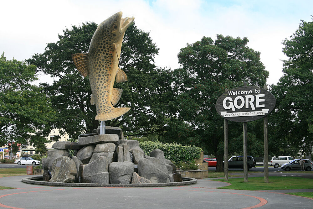 giant brown trout sculpture in gore - world capital of brown trout fishing - with a sign saying welcome to gore