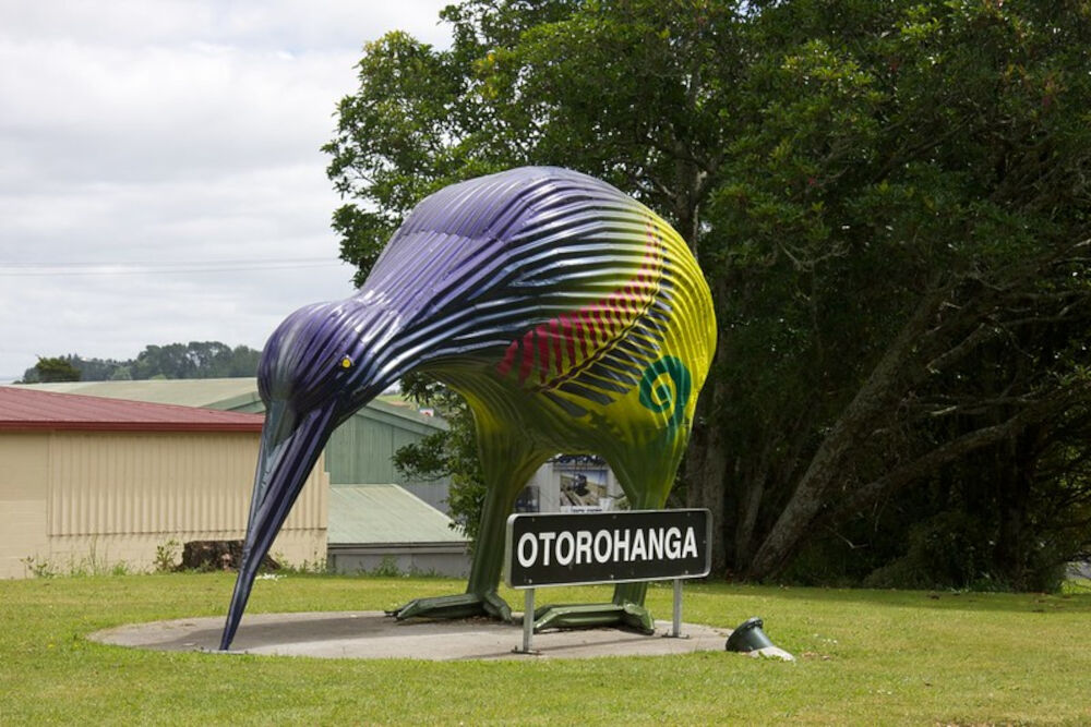 otorohanga corrugated iron giant kiwi sign with new zealand colours painted on and a sign in front saying otorohanga - big things north island