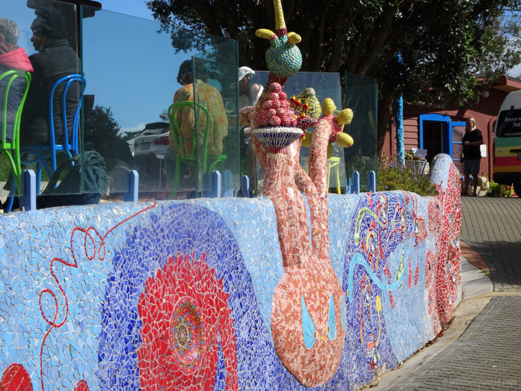 a colorful and decorative ceramic mosaic wall at casita miro winery on waiheke island, mainly blue and red in colour with patterns and swirls