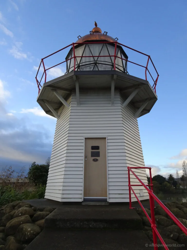 wairoa lighthouse old - portland island lighthouse - white wooden lighthouse with copper dome and red railings and fencing in hawkes bay north island new zealand
