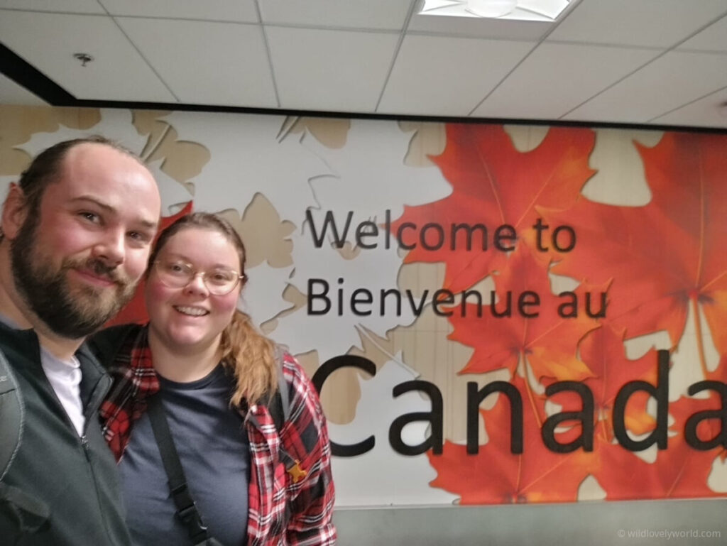 fiachra and lauren with a welcome to canada sign