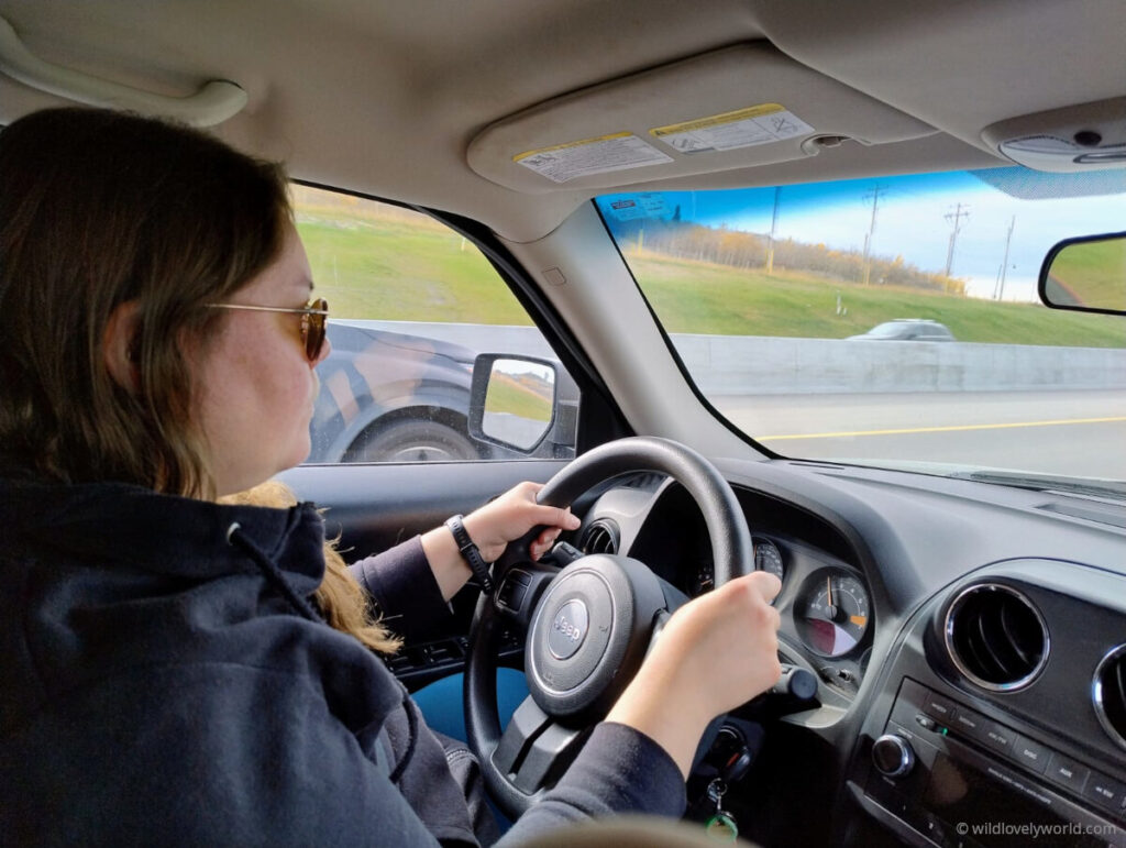 lauren driving a jeep on the highway in alberta canada