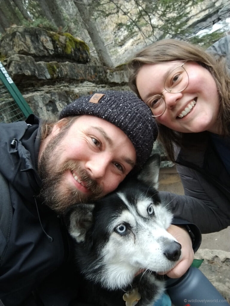 fiachra and lauren smiling with a husky trusted housesitters canada