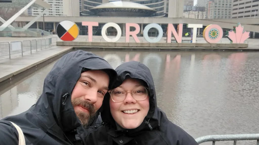 fiachra and lauren take a selfie with the toronto sign