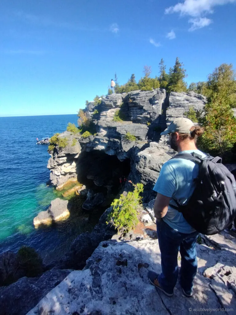 fiachra looking at the blue waters of the grotto on the tobermory peninsula