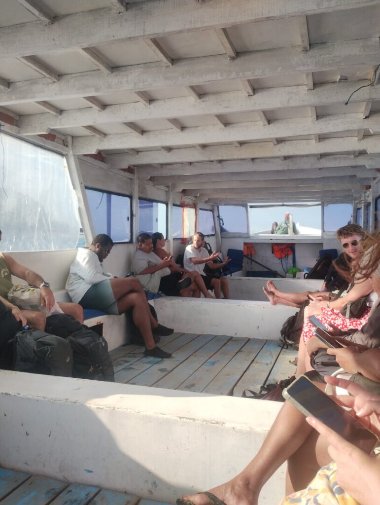 interior of the gili islands island hopping public slow boat showing bench seating and roof cover lombok indonesia