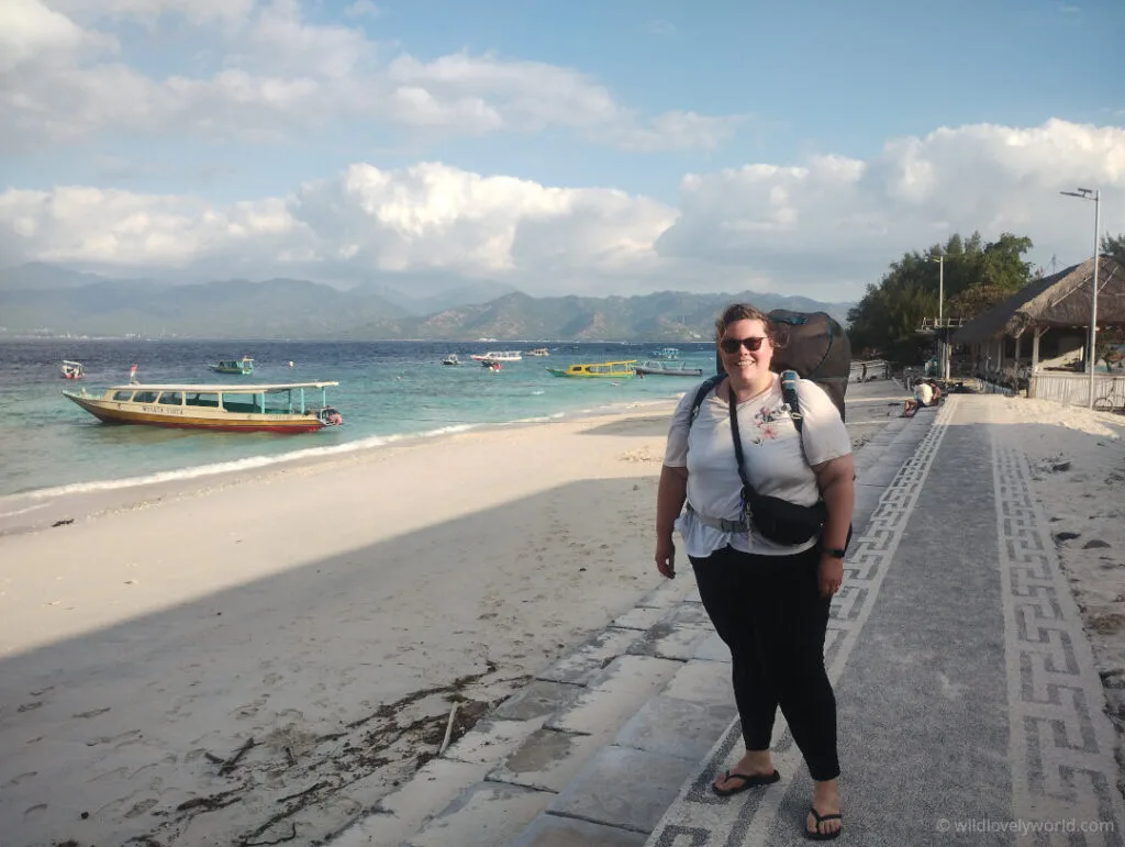 lauren with backpack at the harbour on gili meno