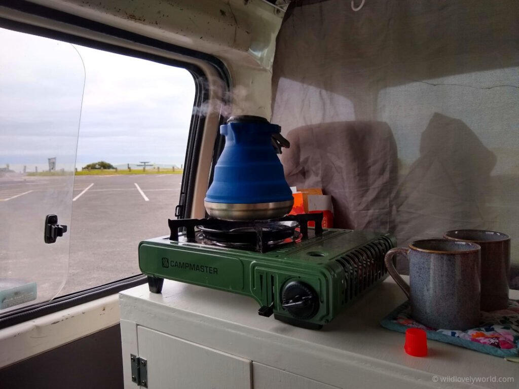 kettle on a gas cooker inside campervan