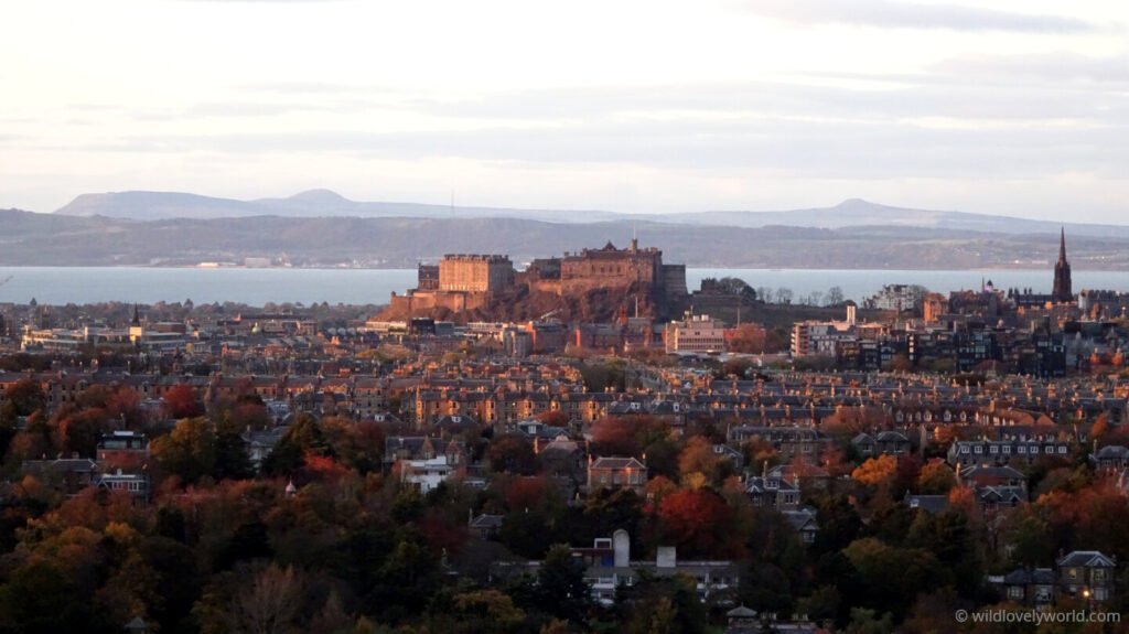 view of edinburgh castle from blackford hill with firth of forth and hills of fife in the distance